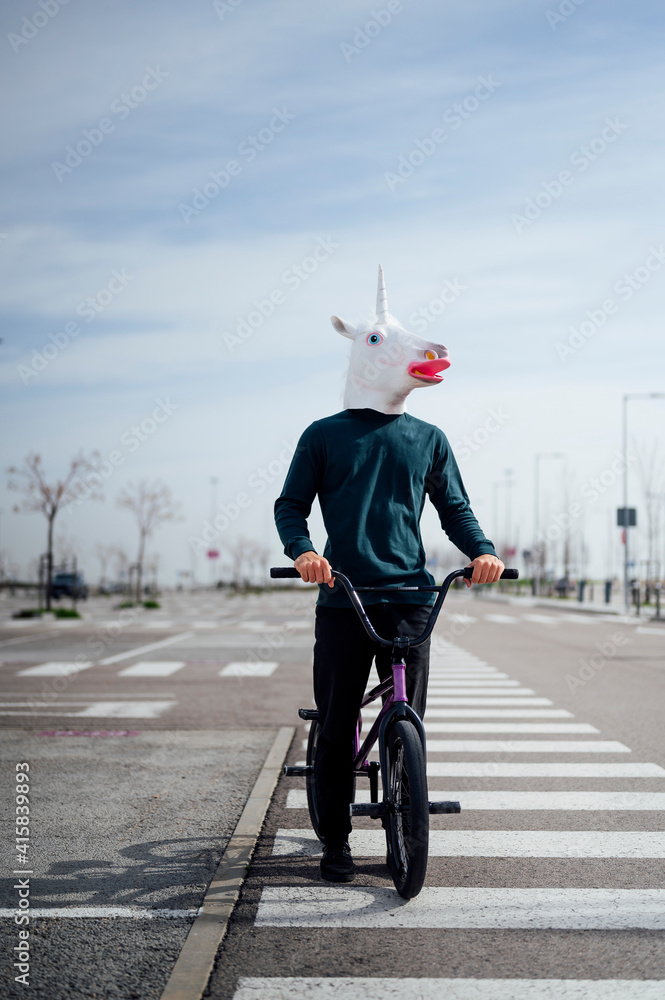Naklejka premium unicorn man with bicycle