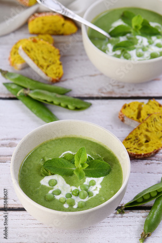 Chilled soup puree of green peas, seasoned with green onion, mint and crunchy toasted diced rusk bread 