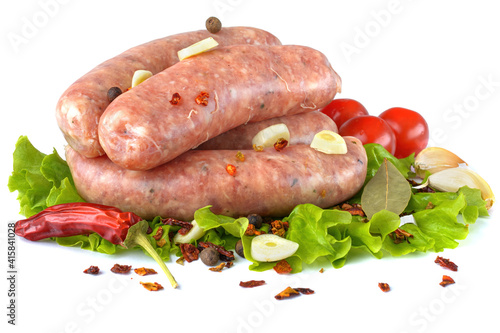 Raw pork sausages. Grilled sausages, spices close-up, isolated on a white background.Selective focus.