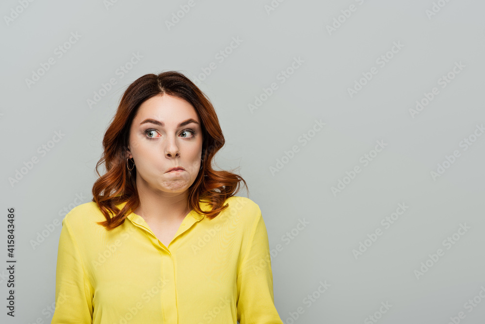 discouraged woman with curly hair looking away isolated on grey discouraged woman with curly hair looking away isolated on grey