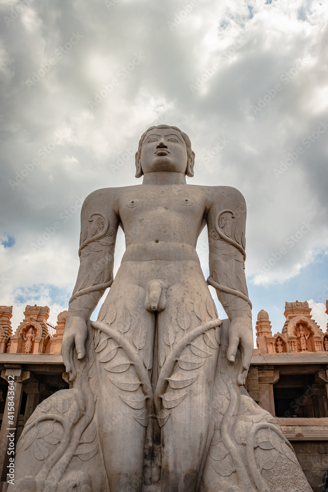 Fototapeta premium idol of a deity stone statue symbolizing Peace in Jainism with blue sky from different angles