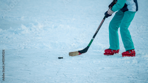 Playing ice hockey on snow-covered ice