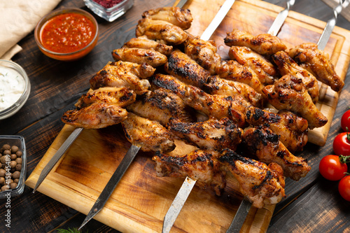 grilled or barbecue chicken wings skewer on board