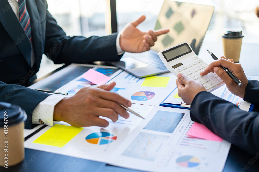 Hands of business people working in the office with documents That represents the investment results of the company Profits between companies that have made a mutual agreement Hands of business people working in the office with documents That represents the investment results of the company Profits between companies that have made a mutual agreement