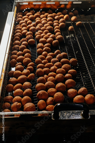 deep-fried donuts. production of donuts in a bakery