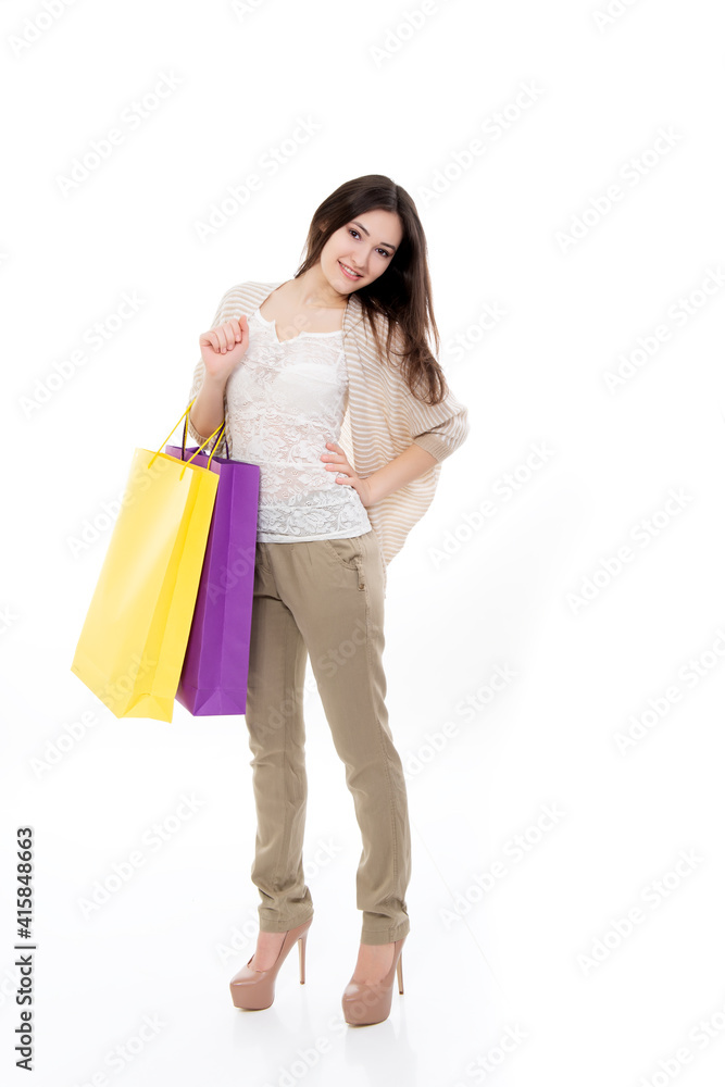 Happy young woman shopaholic with shopping bags at sale time, isolated on white background Happy young woman shopaholic with shopping bags at sale time, isolated on white background
