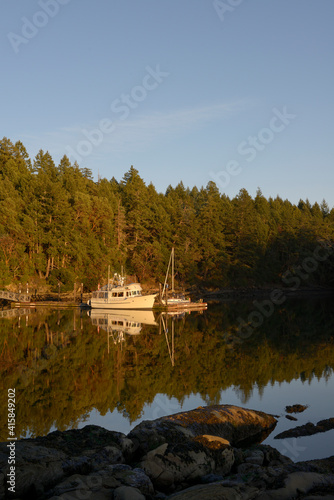 Pleasure boats in still water at the dock in Conover Cove, Wallace Island, Gulf Islands, British Columbia, Canada photo