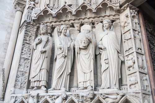 Konstfotografi Statue of St Denis holding his head with other saints on the exterior facade of