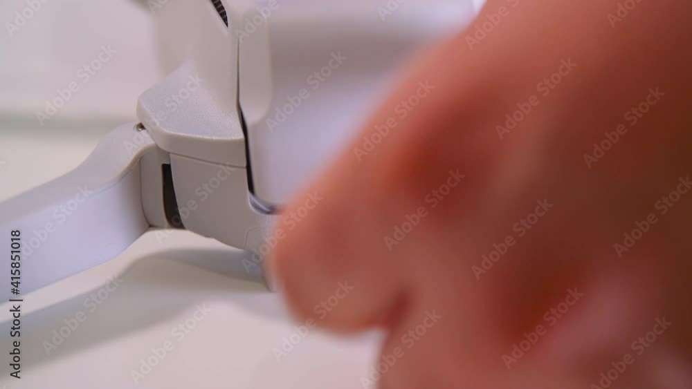 Man's hand replacing battery of new mini drone. Man's hand replacing battery of new mini drone.