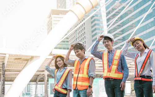 Portrait of engineering group standing near buildings. Construction Concept. © Ann Rodchua