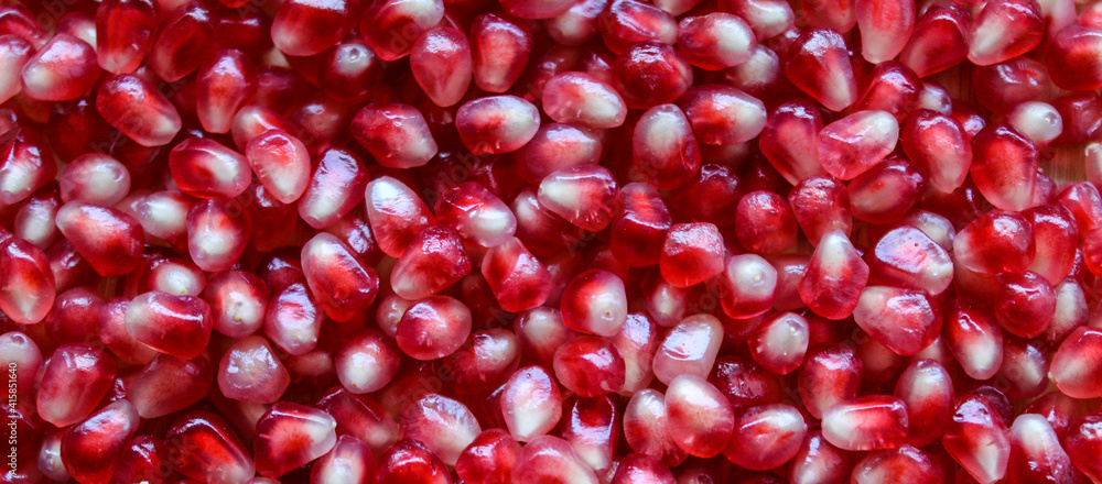 Pomegranate seeds. Macro. Close up. Red pomegranate seeds. Banner. Pomegranate seeds. Macro. Close up. Red pomegranate seeds. Banner.