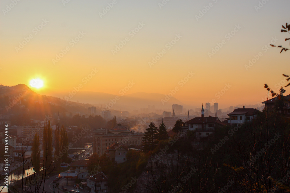 Fototapeta premium Beautiful sunset over Sarajevo and Sarajevo City Hall. Beautiful view of the city and the silhouettes of other sights of the city of Sarajevo.