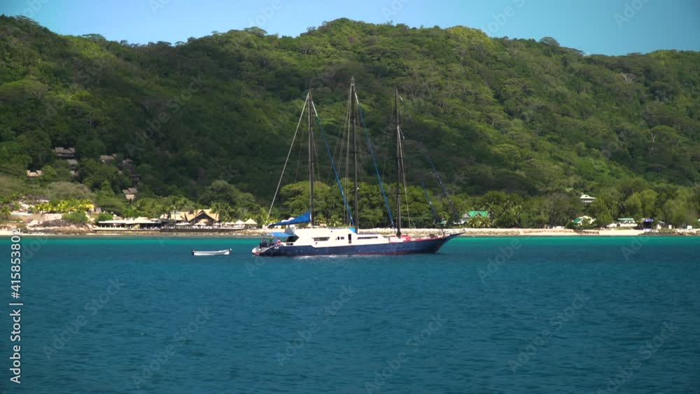 Sailing between the Seychelles islands In the background is tropical rainforest Sailing between the Seychelles islands In the background is tropical rainforest