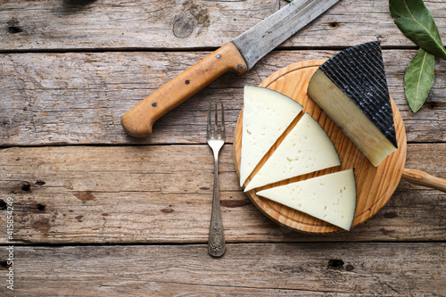 Spanish cured cheese with rustic background photo