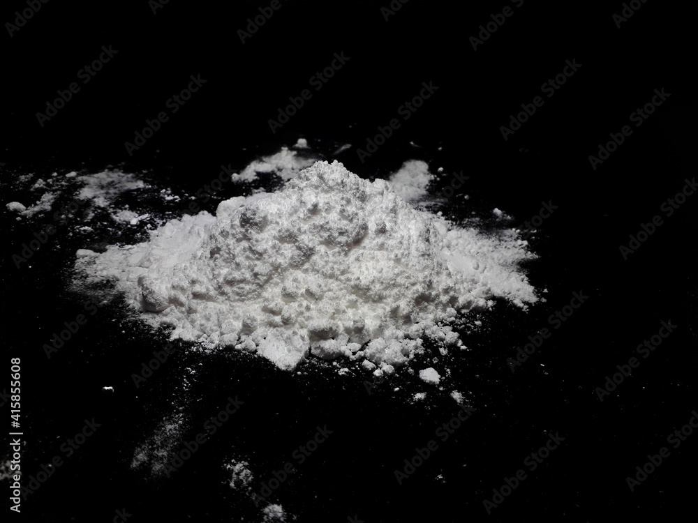 Cocaine drug powder pile on black background Cocaine drug powder pile on black background