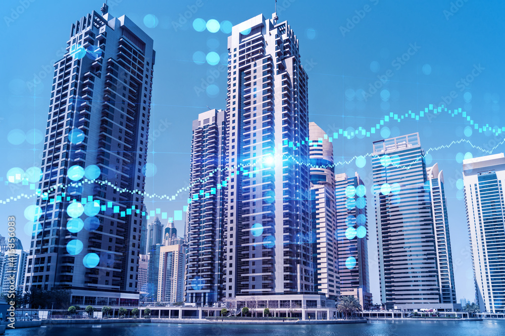 Fototapeta premium Skyscrapers of Dubai business downtown. International hub of trading and financial services of Western Asia. FOREX graph and chart concept. Double exposure. Dubai Canal waterfront.