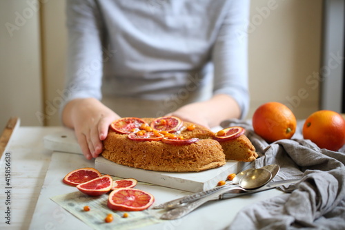 Children's hands decorate the orange pie