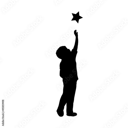Silhouette child boy trying to take the star