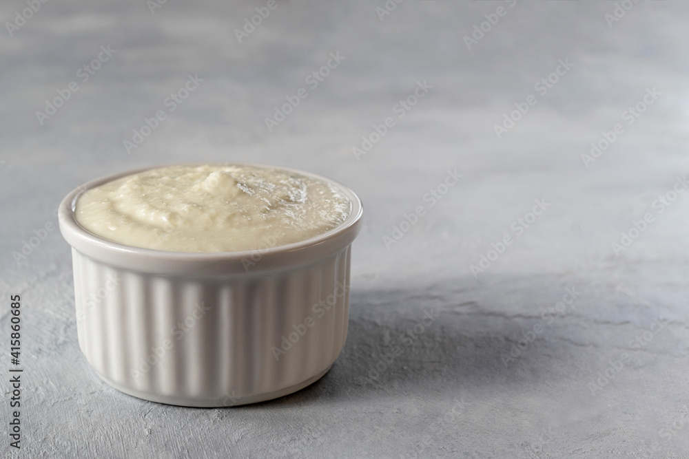 Lebanese Toum garlic sauce. All-purpose garlic sauce (no eggs) as an alternative to mayonnaise. It goes well with all dishes where garlic is appropriate. Selective focus. Lebanese Toum garlic sauce. All-purpose garlic sauce (no eggs) as an alternative to mayonnaise. It goes well with all dishes where garlic is appropriate. Selective focus.