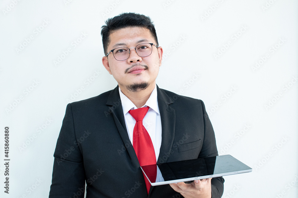 Expert in digital technologies. Cheerful young man in formal wear working on digital tablet and smiling while standing isolated on white background Expert in digital technologies. Cheerful young man in formal wear working on digital tablet and smiling while standing isolated on white background