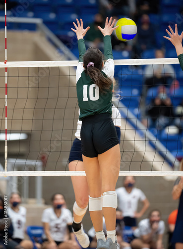 Young athletic girl competing in a volleyball game