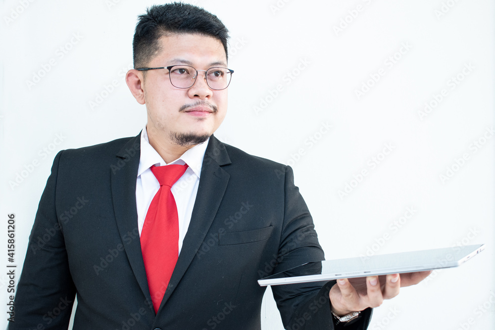 Expert in digital technologies. Cheerful young man in formal wear working on digital tablet and smiling while standing isolated on white background Expert in digital technologies. Cheerful young man in formal wear working on digital tablet and smiling while standing isolated on white background