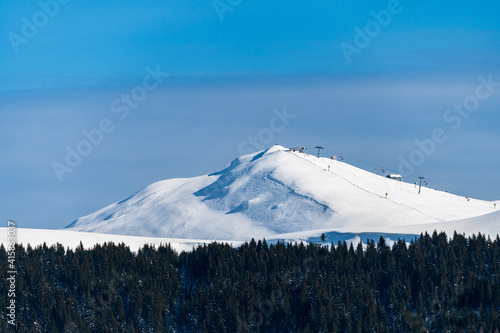 Chairlift on snow covered mountain in Romanian Carpathians