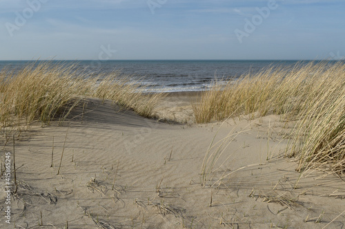 Views out to the open sea through the deserted sand dunes of a beach close to Den Helder, Netherlands