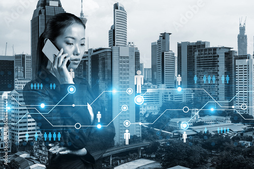Canvas Print Attractive Asian businesswoman processing conference call to develop social media marketing strategy to achieve business goals