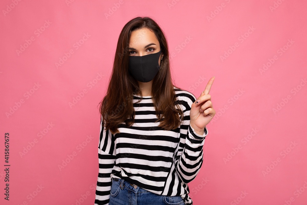 Photo of young attractive woman wearing handmade cotton fabric face mask isolated over colourful background wall. Protection against COVID-19 Photo of young attractive woman wearing handmade cotton fabric face mask isolated over colourful background wall. Protection against COVID-19