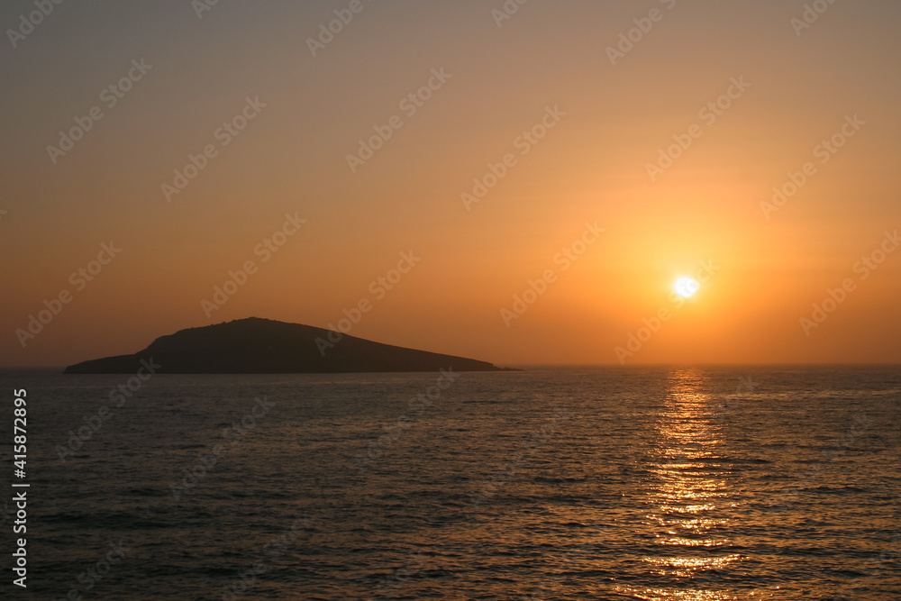 sunset from Kalymnos with a rocky islet in the background sunset from Kalymnos with a rocky islet in the background