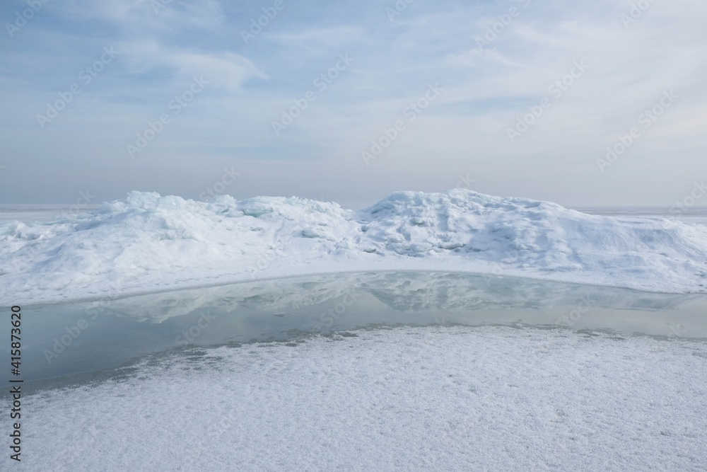 Beautiful scenery of frozen sea in delicate light. Baltic Sea, Puck Bay, Poland