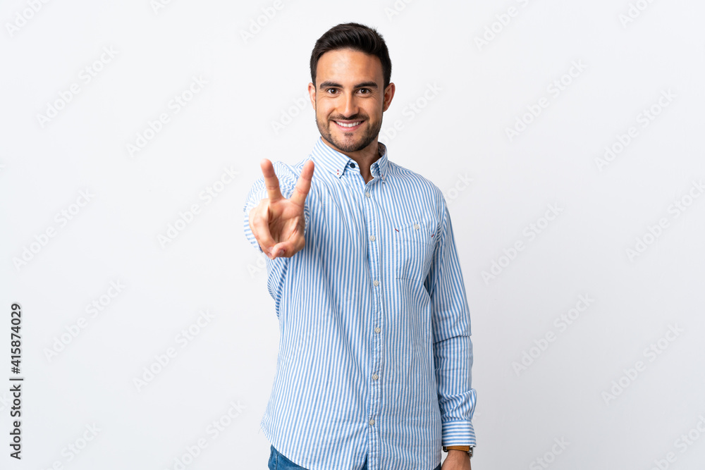 Young handsome man over isolated background smiling and showing victory sign