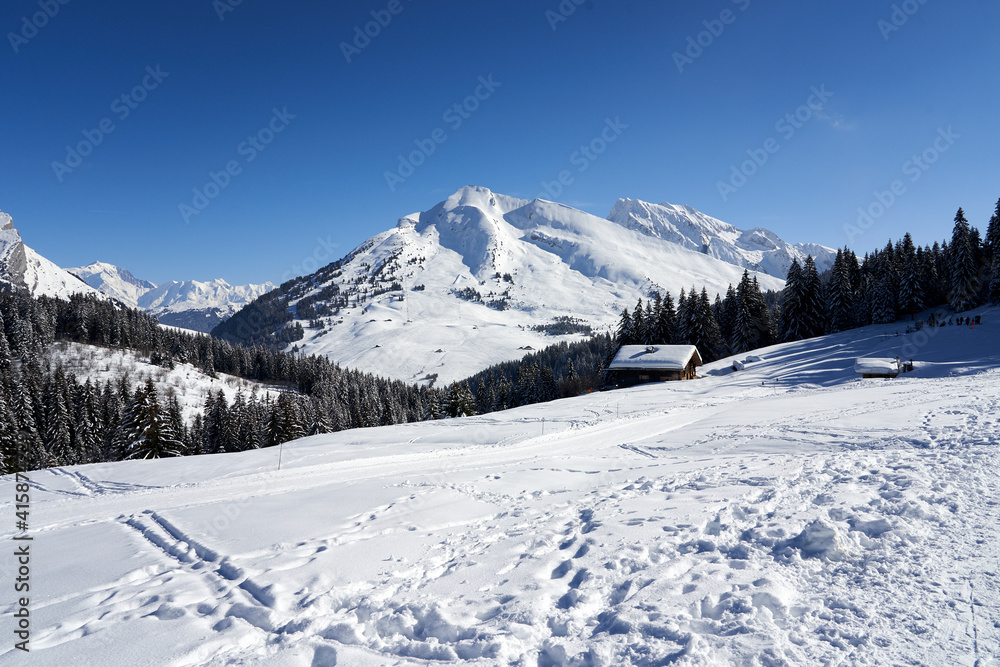 View from mountains with blue sky and chalet at Plateau de Beauregard