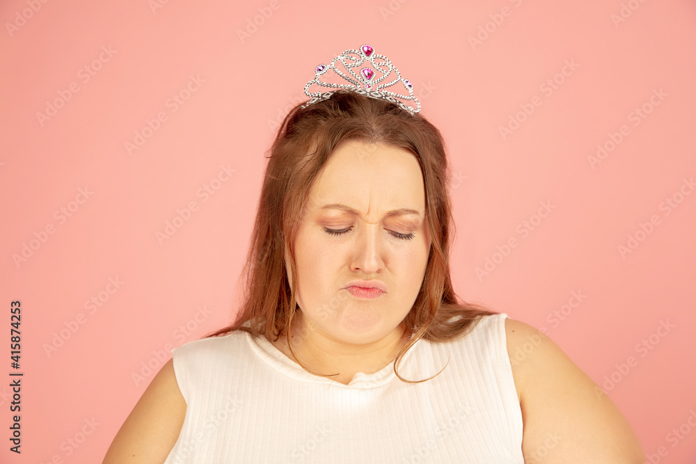 Close up. Beautiful plump caucasian plus size model in fairy's outfit on pink studio background. Concept of inclusion, human emotions, facial expression, sales, body positive. Copyspace for ad. Close up. Beautiful plump caucasian plus size model in fairy's outfit on pink studio background. Concept of inclusion, human emotions, facial expression, sales, body positive. Copyspace for ad.