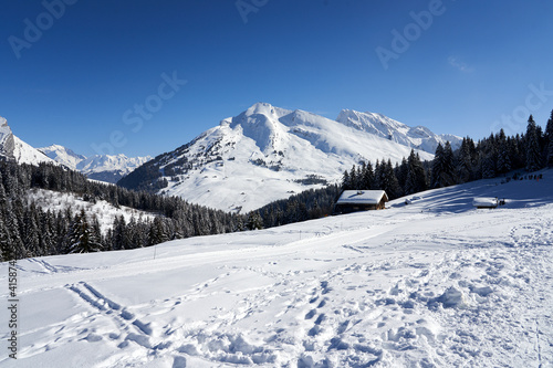 View from mountains with blue sky and chalet at Plateau de Beauregard © Alexandre