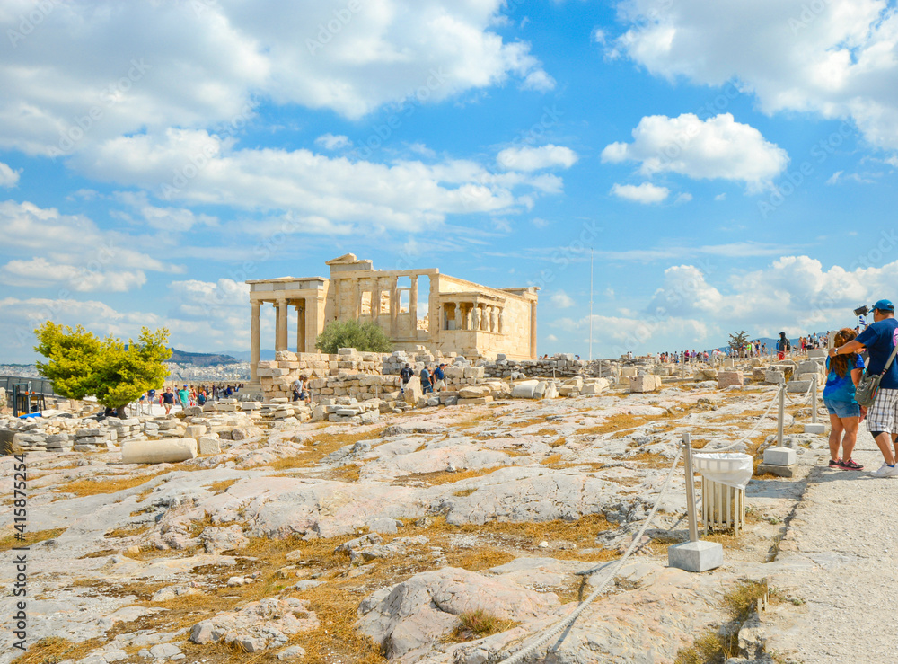A summer day in Athens Greece as tourists enjoy the city view and explore the ancient Erechtheion on Acropolis Hill, a world heritage site