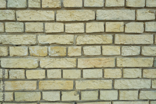 Peeled old brick wall. Brick yellow background.