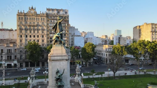Aerial orbit of Monument of Two Congresses in Congressional Plaza surrounded by Balvanera buildings at sunset, Buenos Aires photo