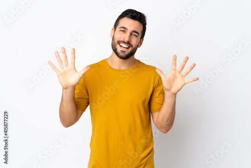 Young handsome man with beard isolated on white background counting ten with fingers