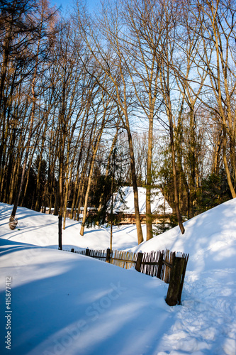  Traditional village wooden house in winter, historic country-style architecture