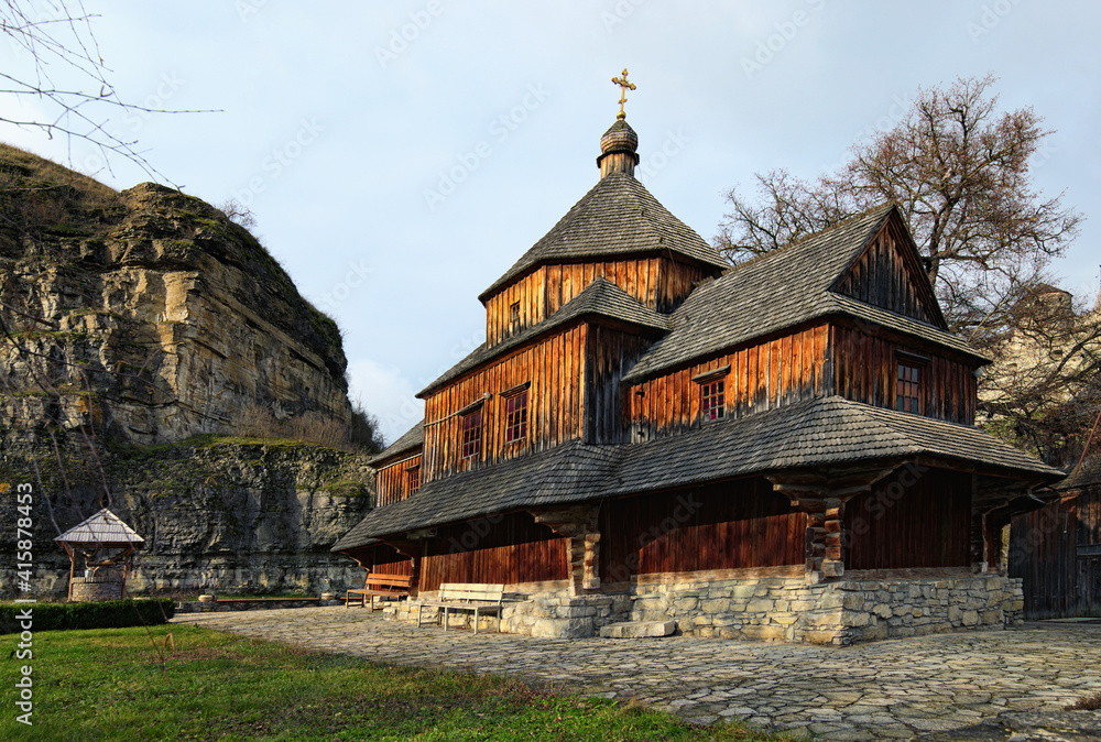 Beautiful landscape photo of medieval wooden Church of the Exaltation of the Cross. Kamianets-Podilskyi, Ukraine. Christian Orthodox church. Travel and tourism concept Beautiful landscape photo of medieval wooden Church of the Exaltation of the Cross. Kamianets-Podilskyi, Ukraine. Christian Orthodox church. Travel and tourism concept
