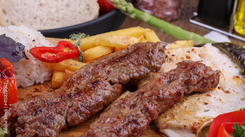 grilled kebab with fried potatoes and rice

