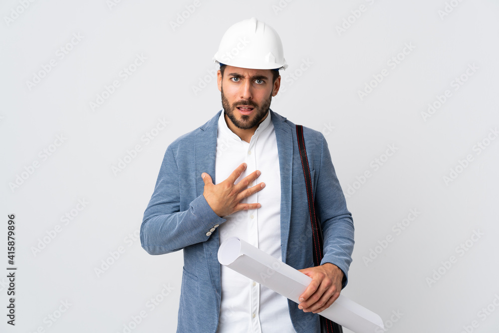 Young architect man with helmet and holding blueprints isolated on white background pointing to oneself Young architect man with helmet and holding blueprints isolated on white background pointing to oneself