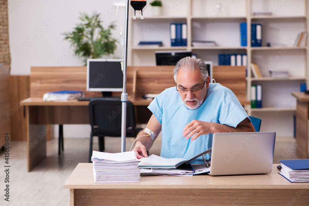 Old male employee in blood transfusion concept Old male employee in blood transfusion concept