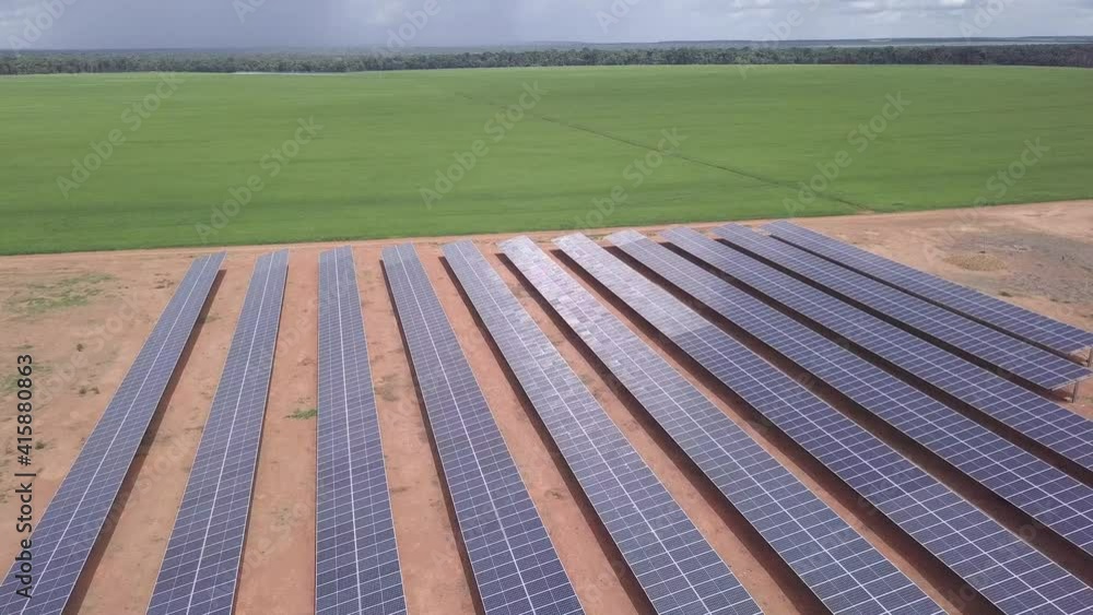 Aerial drone view of solar panels on sunny summer day to generate clean renewable energy and soy agriculture farm. Concept of sustainability, ecology, sustainable, electricity, business. 4k. Aerial drone view of solar panels on sunny summer day to generate clean renewable energy and soy agriculture farm. Concept of sustainability, ecology, sustainable, electricity, business. 4k.
