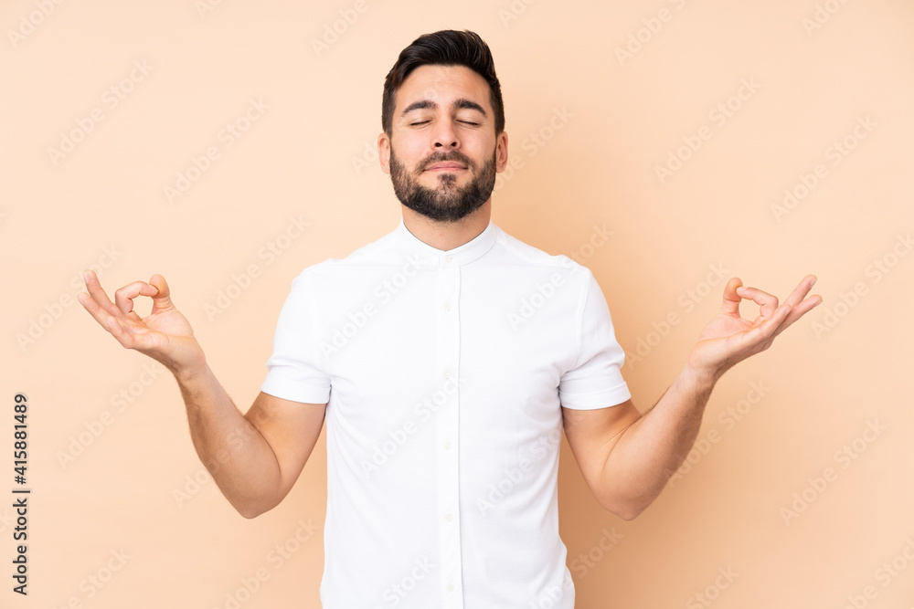 Caucasian handsome man isolated on beige background in zen pose Caucasian handsome man isolated on beige background in zen pose
