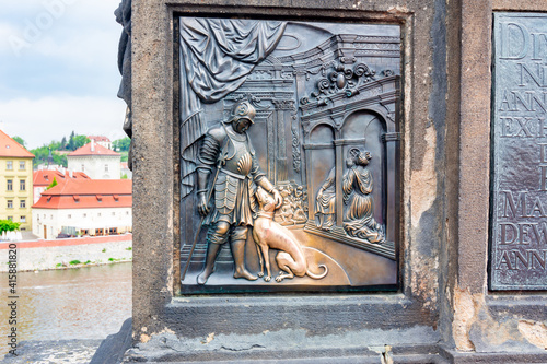 Photography Relief of dog under statue of St
