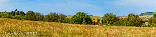 Panoramic landscape view of traditional saxon Viscri village with the fortified evangelical church in Viscri, Brasov country, Transylvania, Romania photo