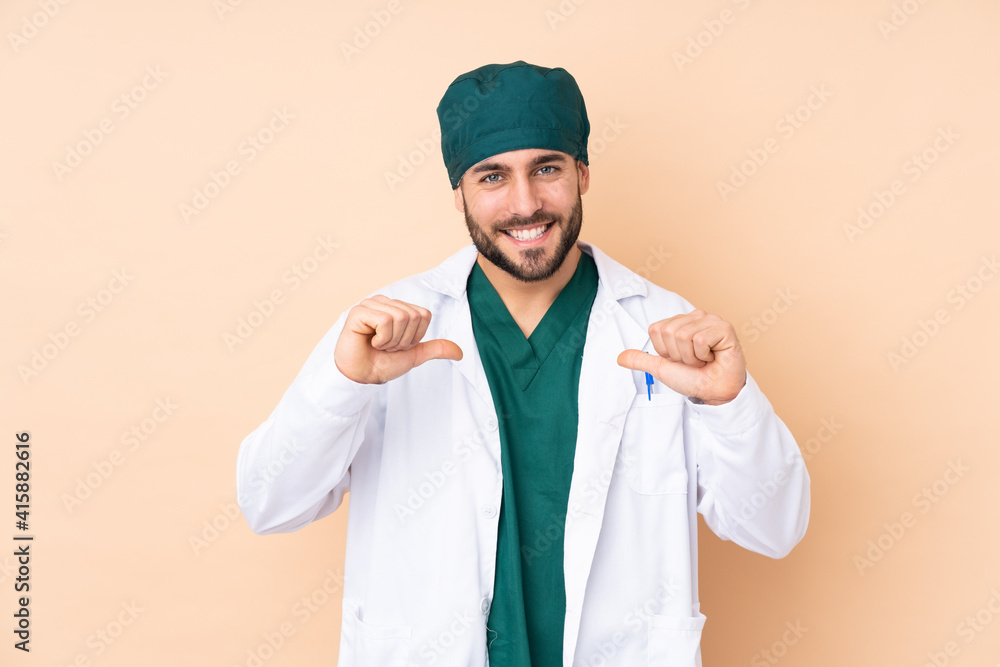 Surgeon man isolated on beige background proud and self-satisfied